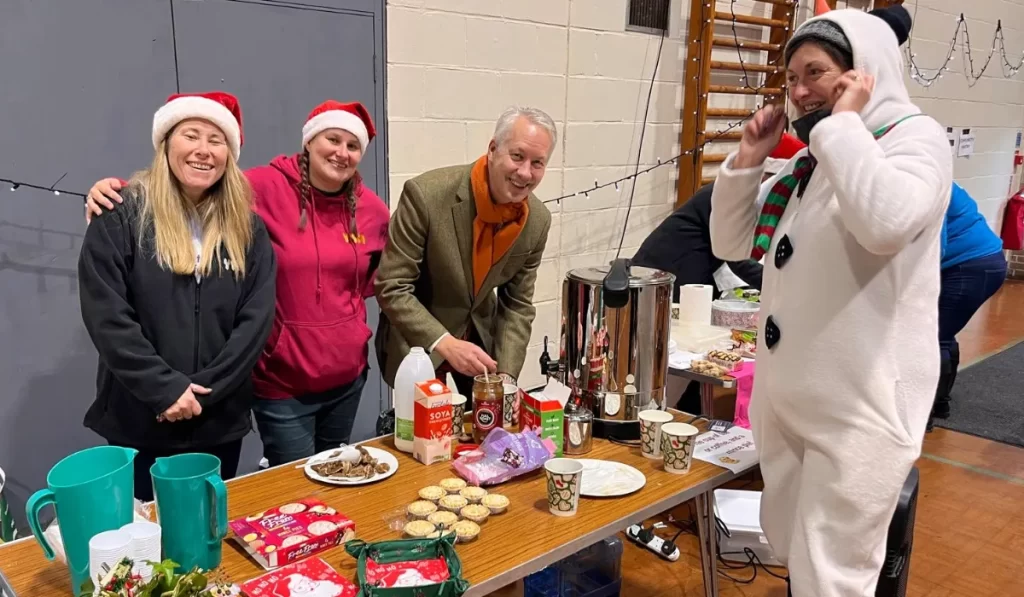 staff and gideon amos serving free drinks at YMCA Festive Fayre